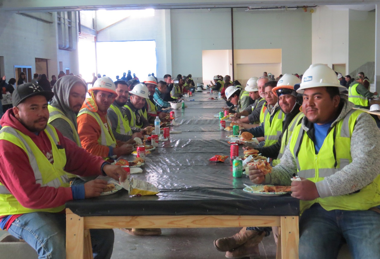 Hellas Construction crew enjoying food at the Toys for Tots drive, where they are installing a football field and track for the new Dripping Springs school.