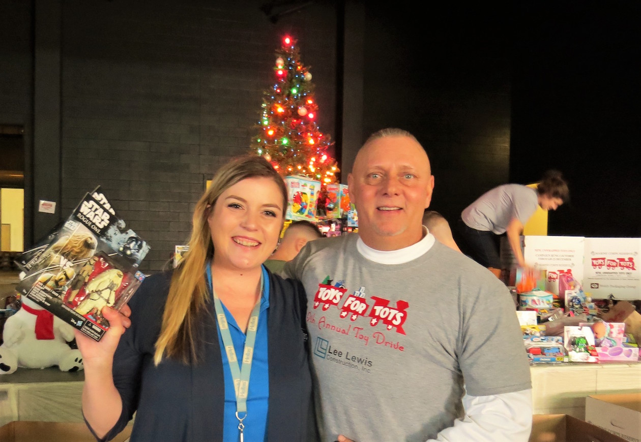 Hellas Project Manager Lia Risner with Lee Lewis Construction Superintendent  Leroy Beaver collecting toys for the Toys for Tots drive at the new Dripping Springs school.