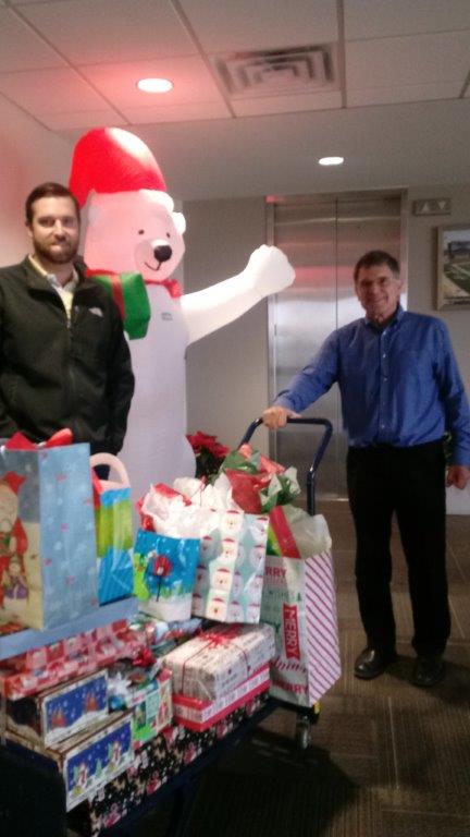 Kyle Mahlen and Bob Allison delivering gifts from Hellas to families through the Blue Santa program.
