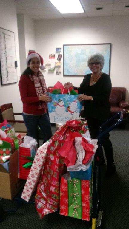 Zaide Viesca and Patricia Roy organizing gifts to be delivered through the Blue Santa program Hellas Construction participated in this year.