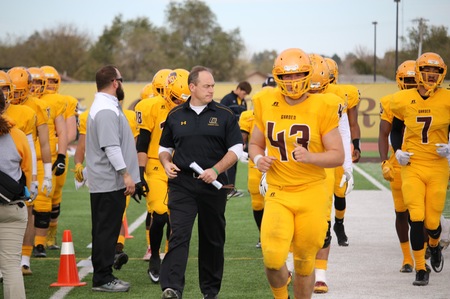 GCCC Head Coach Jeff Sims and Broncbuster players warming up before a game.