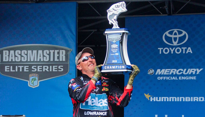 Wesley Strader holds the Berkley Bassmaster Tournament Trophy on stage in Paris, Tennessee at Kentucky Lake on May 7, 2018, where he took first place.